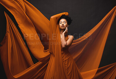 Buy stock photo Black woman, art and fashion, flowing fabric on dark background with beauty and aesthetic movement. Silk, fantasy and artistic portrait of serious African model in creative designer dress in studio.