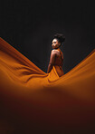 Black woman, art and fashion, fabric on dark background with mockup and aesthetic movement. Flowing silk, fantasy and artistic portrait of serious African model in creative designer dress in studio.