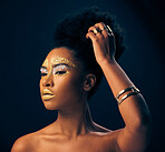 Beauty, gold and glitter with black woman and makeup in studio for luxury, cosmetics or African pride. Natural, creative and goddess with female model on black background for queen, bronze or glamour