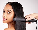 Woman flat iron and studio portrait with hair care, wellness and heat treatment by white background. Girl, model and healthy glow at hairdresser with electric tools for cosmetics, change and beauty