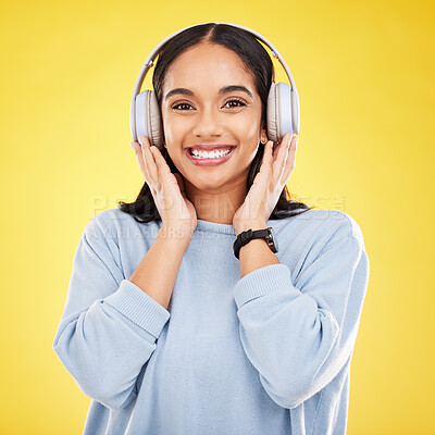 Buy stock photo Happy, music and headphones with portrait of woman in studio for streaming, online radio and audio. Smile, media and podcast with female on yellow background for technology, listening and connection