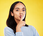 Secret, portrait and woman with finger on lips in studio, yellow background and privacy sign. Face of female model, silence and shush for quiet, gossip and whisper emoji for confidential mystery news