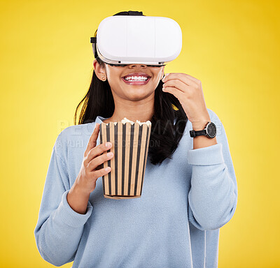 Buy stock photo Woman is eating popcorn, happy and VR goggles with snack for watching tv or movie on yellow studio background. Future technology, female with virtual reality experience and corn treat, cinema and UX 