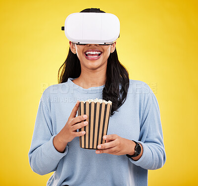 Buy stock photo Woman is eating popcorn, happy and VR goggles, snack for watching tv or movie on yellow studio background. Future technology, virtual reality experience and corn treat, cinema and UX with metaverse