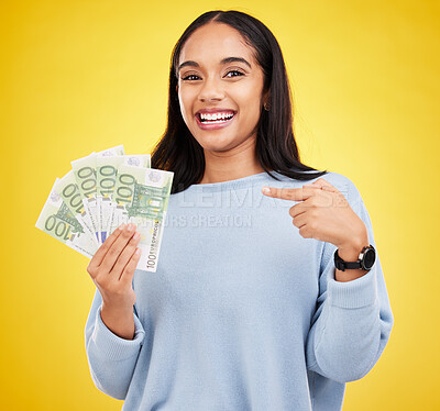 Buy stock photo Woman, happy and cash in studio portrait for bonus, winning or profit by yellow background. Young student girl, winner and money fan with pointing at bills for celebration of success on stock market