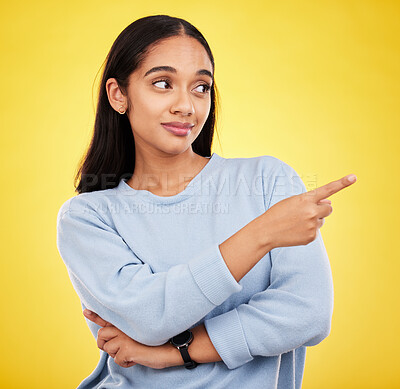 Buy stock photo Yellow background, point and face of woman in studio for advertising, promotion and announcement. Mockup space, news and isolated girl with hand gesture showing information, discount and branding