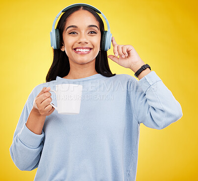 Buy stock photo Coffee, music and headphones with portrait of woman in studio for streaming, online radio and relax. Smile, media and podcast with female on yellow background for technology, listening and connection