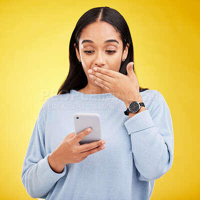 Buy stock photo Shock, surprise and woman in studio with phone and hand on mouth isolated on yellow background. Social media, fake news or exciting online promotion, hispanic girl reading notification on smartphone.