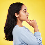 Woman, profile and studio with a young model thinking with casual fashion feeling relax. Isolated, yellow background and gen z female person with youth and healthy hair care posing and relaxing 