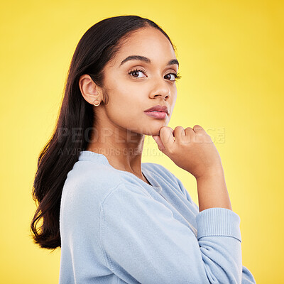 Buy stock photo Portrait, thinking and a woman on a yellow background in studio feeling thoughtful or contemplative. Face, idea and an attractive young female standing hand on chin while contemplating a thought