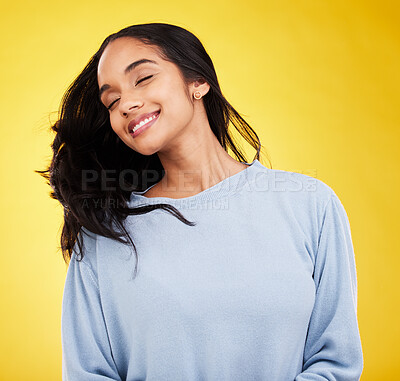 Buy stock photo Young woman, hair and beauty, happy and satisfaction with gen z, fashion on yellow studio background. Happiness, youth and Indian female with smile, haircare and cosmetics with growth and shine