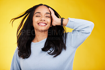 Buy stock photo Happy, freedom and relief with a woman on a yellow background in studio feeling carefree or cheerful. Smile, relax and calm with an attractive young female posing eyes closed in a peaceful mood