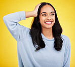 Thinking, smile and a woman on a yellow background in studio contemplating a happy memory. Idea, vision and mindset with an attractive young female looking thoughtful about the distant future