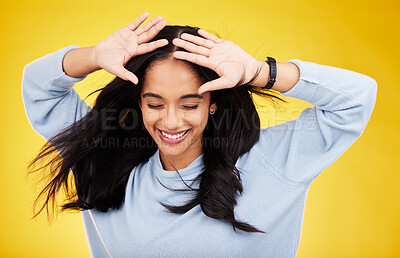 Buy stock photo Happy, freedom and calm with a woman on a yellow background in studio feeling carefree or cheerful. Smile, relax and relief with an attractive young female posing eyes closed in a peaceful mood