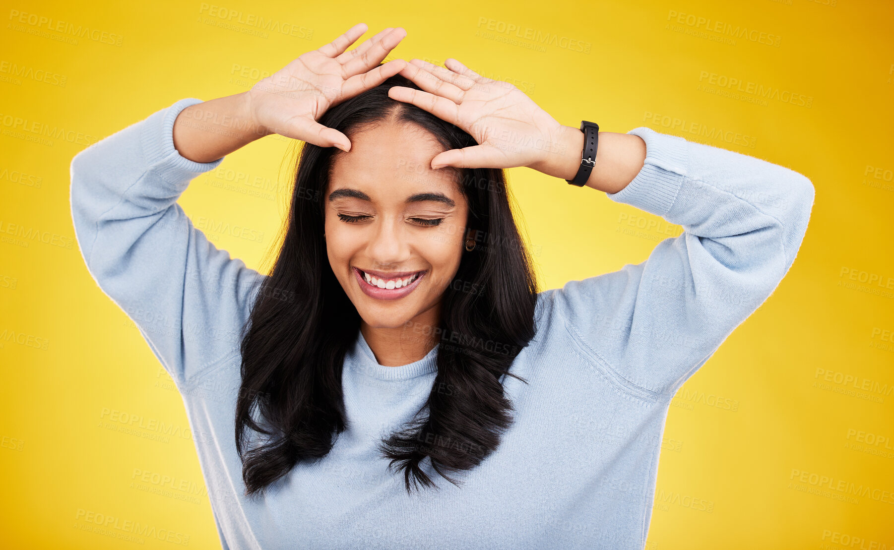 Buy stock photo Happy, dance and face of woman on yellow background for positive mindset, happiness and freedom. Smile, mockup space and isolated girl with hands on head for dancing, relaxing and calm in studio