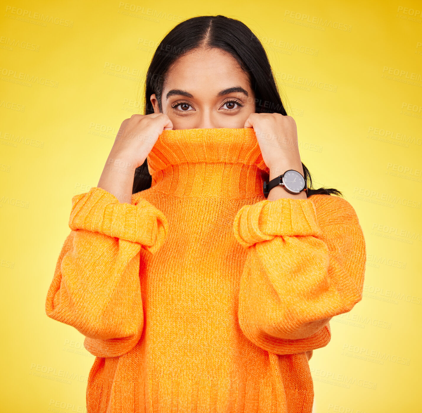 Buy stock photo Cold, cover and portrait of a woman with a jersey isolated on a yellow background in a studio. Hiding, winter and a girl holding a jumper up for covering, warmth and bad weather on a backdrop