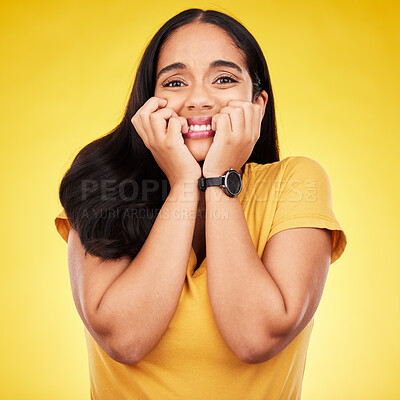 Buy stock photo Nervous, fear portrait and woman in a studio with stress and anxiety with nail biting. Isolated, yellow background and panic of a scared person feeling terror, phobia and mental health problem