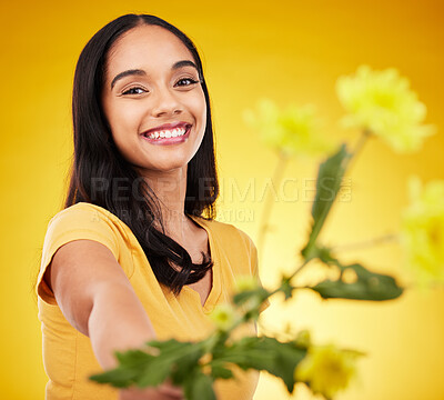Buy stock photo Happy, summer and portrait of woman with flowers or plants feeling excited and isolated in a studio yellow background. Smile, happiness and young female holding a gift with a floral blossom aesthetic