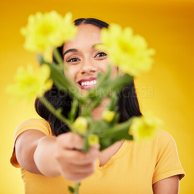 Buy stock photo Happy, portrait and woman with flowers as a gift isolated on a yellow background in a studio. Floral, spring and girl giving a bouquet as a present, sharing plants and fresh flower with a smile