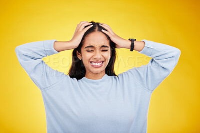 Buy stock photo Young woman, stress and frustrated with headache, pain and distress isolated on yellow studio background. Female holding head, mental health and anxiety with depression, migraine and trauma 
