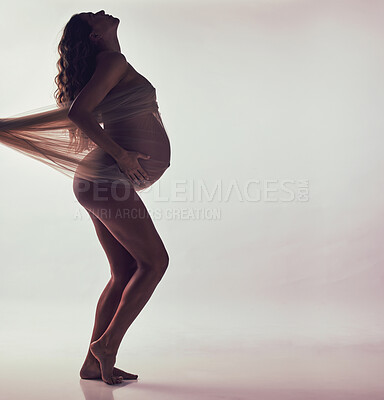 Buy stock photo Woman, pregnancy and fabric on stomach in studio with hands, touch and art by white background. Pregnant model, shadow and wellness mockup with cloth for body, belly or silhouette with dark aesthetic