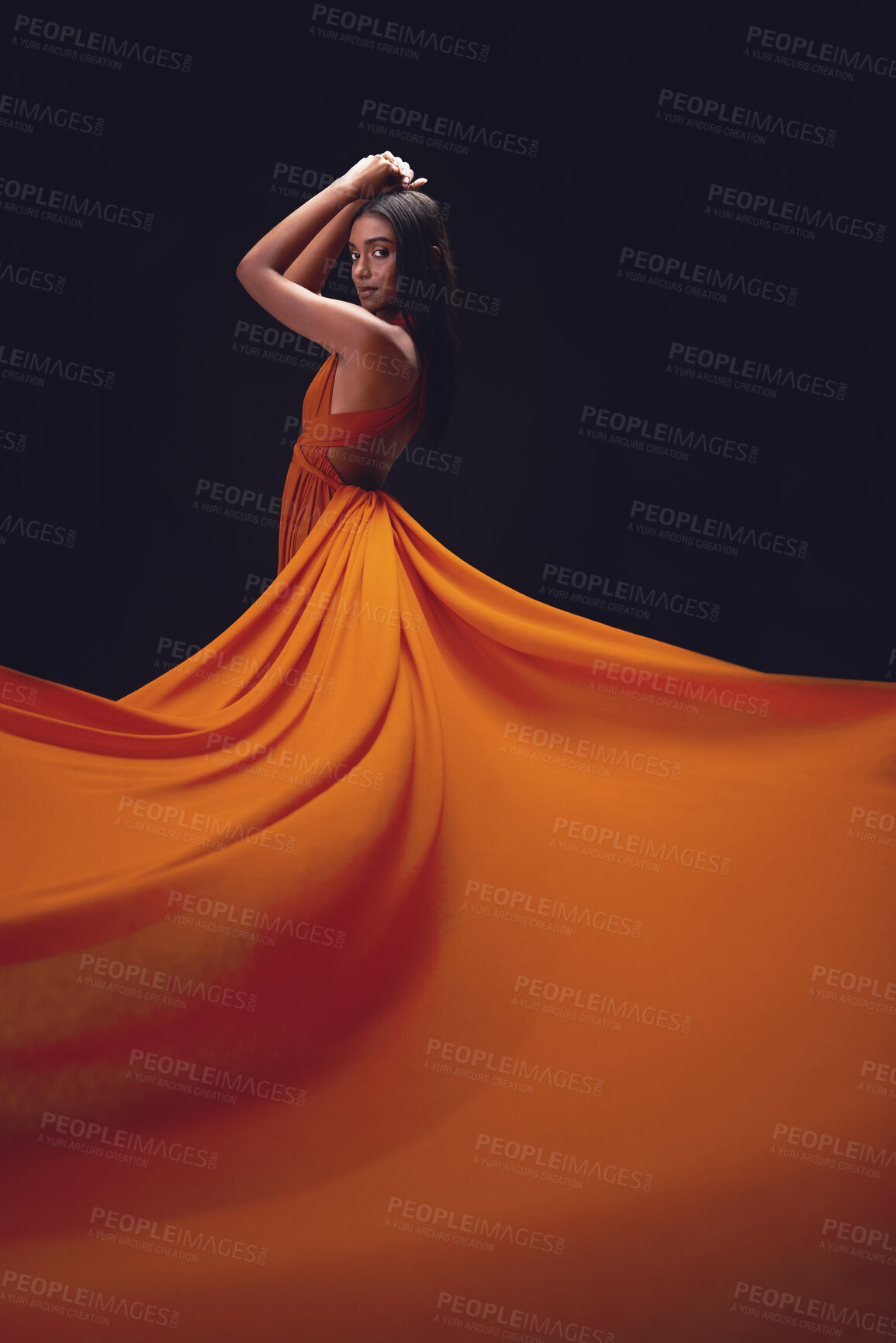 Buy stock photo Fashion, woman and elegant with beauty on dark background, portrait and model in orange dress in studio. Indian female, glamour and stylish ballgown with sexy person, luxury style and designer wear