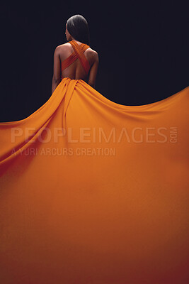 Buy stock photo Dress, train and woman back, elegant style and beauty on dark background, fashion and model in orange in studio. Classy female, glamour and stylish ballgown with sexy person, luxury and designer wear