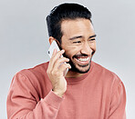 Asian man, phone call and laughing for funny conversation, discussion or joke against a white studio background. Happy male laugh and talking on mobile smartphone for fun chat, communication or meme