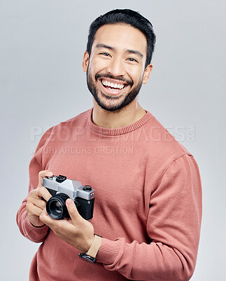 Buy stock photo Portrait, studio and man with camera, tourist and  photographer against a grey background. Face, male creative and guy with smile, photography and artist with happiness, memories and capture moment