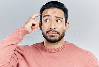 Buy stock photo Thinking, question and doubt with a man in studio on a gray background looking thoughtful or contemplative. Confused, idea and memory with a young asian male trying to remember but feeling unsure