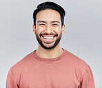 Face portrait, smile and happy Asian man in studio isolated on a gray background or backdrop. Funny, beauty and young, confident and proud handsome male model from Singapore smiling, joy and cheerful