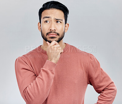 Buy stock photo Confused, thinking and Asian man with ideas, decision and thoughtful against grey studio background. Japan, male and guy with wonder, opportunity and confused with thoughts, contemplation and future 