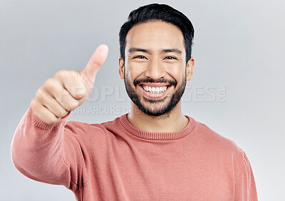 Buy stock photo Portrait, great and Asian man with thumbs up, vote and happiness against a studio background. Face, Japanese male and guy with gesture for well done, promotion and agreement with smile and approval