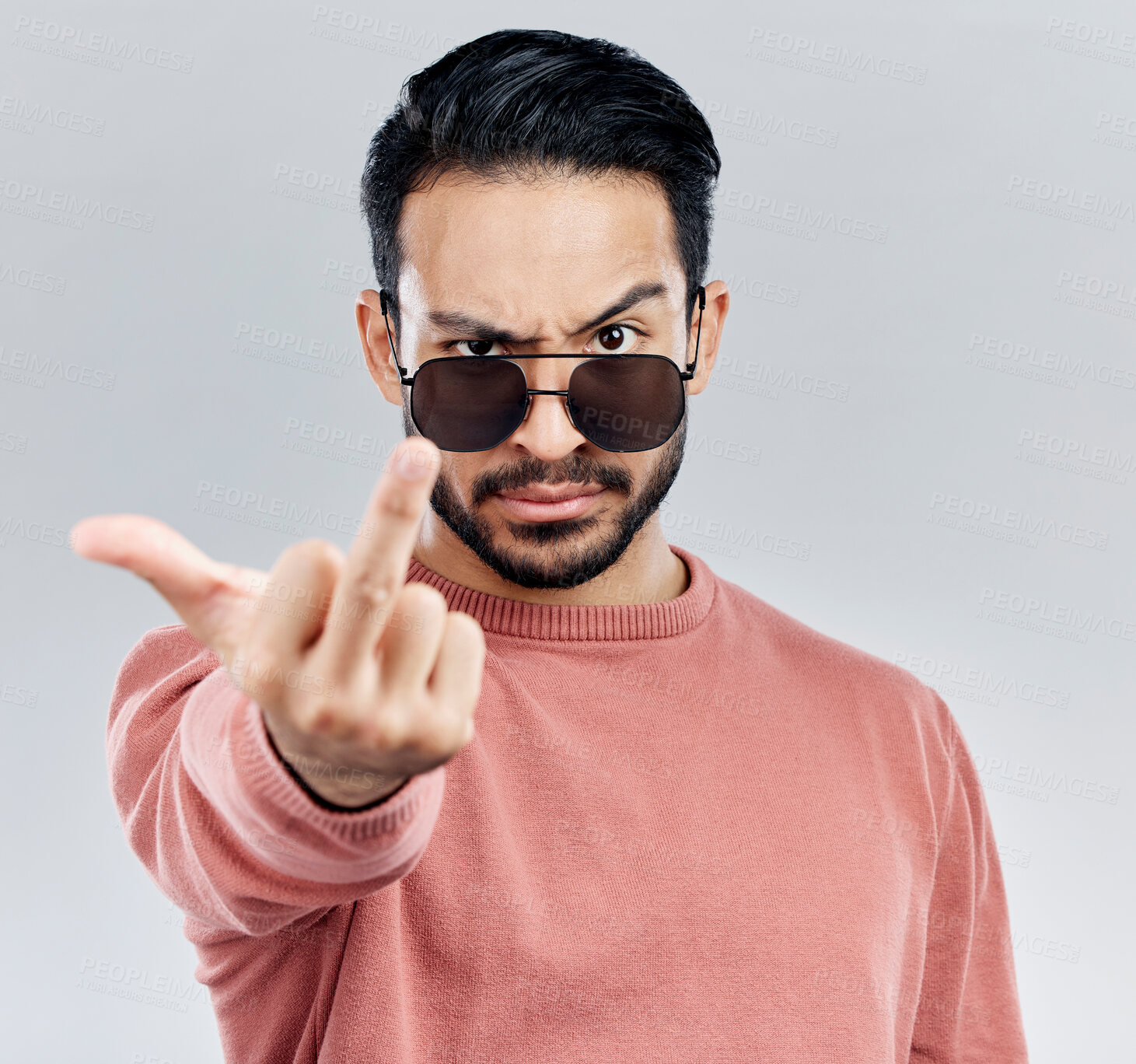 Buy stock photo Hand, middle finger and portrait of man in studio with sunglasses, attitude and gesture against grey background. Face, rebel and emoji by asian male edgy, expression and personality while isolated