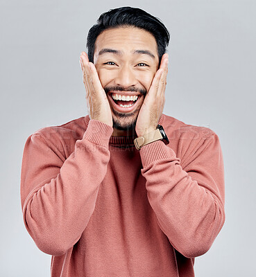 Buy stock photo Portrait, surprise and Asian man excited, wow and happiness against a grey studio background. Face, Japanese male and happy guy with victory, winning and smile with joy, good news and announcement