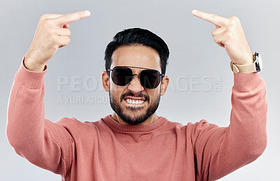 Buy stock photo Portrait, rude and man with anger, middle finger and frustrated against grey studio background. Face, male and guy with offensive hand gesture, aggressive and conflict with expression and disrespect
