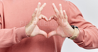 Buy stock photo Hands, heart and man with love in studio to show support, thank you or charity sign language. Male model person with hand icon for kindness, care and hope review, motivation or emoji opinion feedback