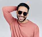 Cool, funny and funky Asian man with sunglasses isolated on a white background in a studio. Portrait, comic and a laughing stylish Chinese guy with fashionable eyewear and crazy gesture on a backdrop