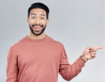 Buy stock photo Excited, gesture and portrait of Indian man pointing at mockup and product placement isolated on white background. Promotion, information and person showing deal space in studio with launch idea.