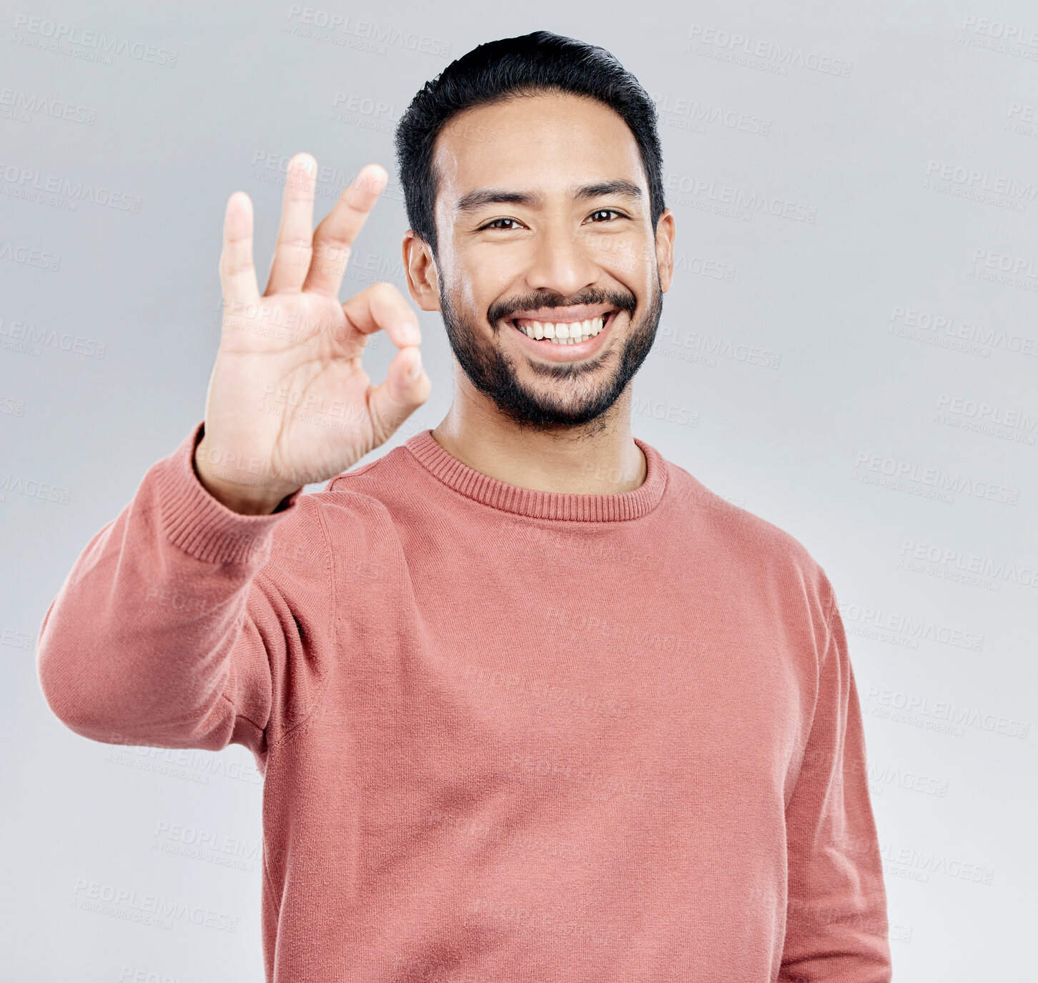 Buy stock photo Hand, portrait and okay sign by man in studio with yes, vote or approval gesture against grey background. Finger, emoji and perfect symbol by asian male happy with decision, thank you or satisfied 