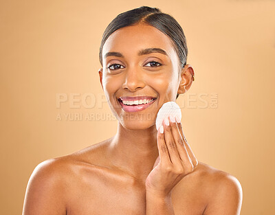 Buy stock photo Skincare, happy and portrait of woman with cotton for facial cleansing isolated on a background. Smile, beauty and an Indian model cleaning her face with a pad for gentle treatment and makeup removal