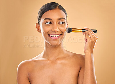 Buy stock photo Indian woman, beauty and brush for makeup with smile, cosmetic tools, skin glow and face on studio background. Happy female, thinking and cosmetology, apply foundation or powder with self care