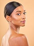 Beauty, portrait and face of woman in studio for skincare, cosmetics, dermatology or makeup. Aesthetic female skin for self care, natural glow and spa facial shine results on a brown background