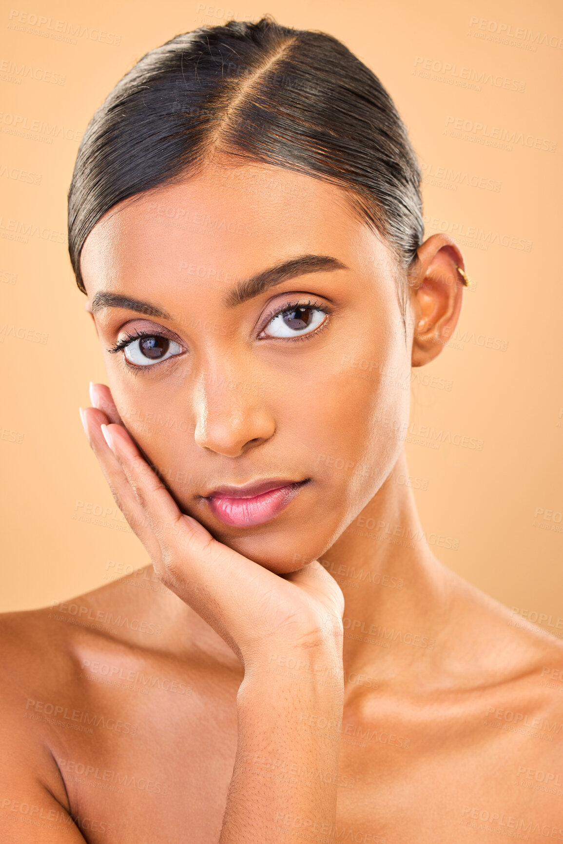 Buy stock photo Skincare, face portrait and beauty of woman in studio isolated on brown background. Makeup, serious cosmetics and confident Indian female model with spa facial treatment for healthy or flawless skin.