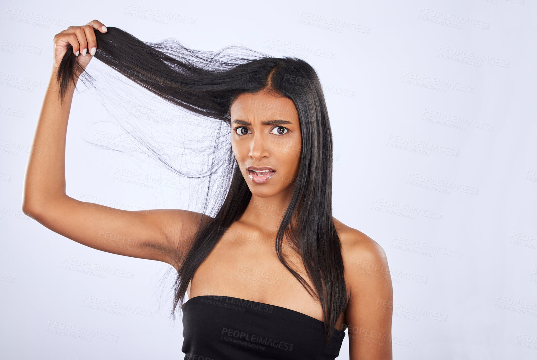 Buy stock photo Hair damage, breakage and portrait of a frustrated woman isolated on a white background in studio. Bad, unhappy and an Indian girl sad about split ends, tangled hairstyle and frizzy haircare