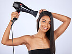 Indian woman, hair care or hair dryer in studio portrait for healthy natural shine, freedom or wellness. Face of glowing happy girl model, salon or self care cosmetics in grooming on white background