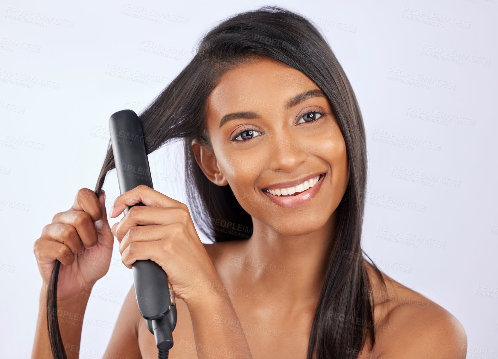 Buy stock photo Beauty, health and woman with hair straightener in studio for a straight, long and healthy hairstyle. Happy, smile and portrait of female model with flat iron after hair treatment by gray background.