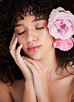 Flowers, rest and face of woman with makeup, cosmetics and beauty for wellness, glamour and glow in studio. Salon aesthetic, spa and girl with closed eyes for natural, skincare and facial treatment