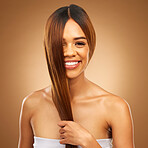 Haircare, smile and portrait of woman in studio holding strong hair in hand with texture and shine. Happy model, mockup and beauty, healthy straight hairstyle with keratin product on brown background