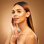 Woman with hand on face, skin and haircare with bronze glow and luxury salon treatment on brown background. Beauty, makeup and skincare cosmetics, hispanic model with straight hair style in studio.